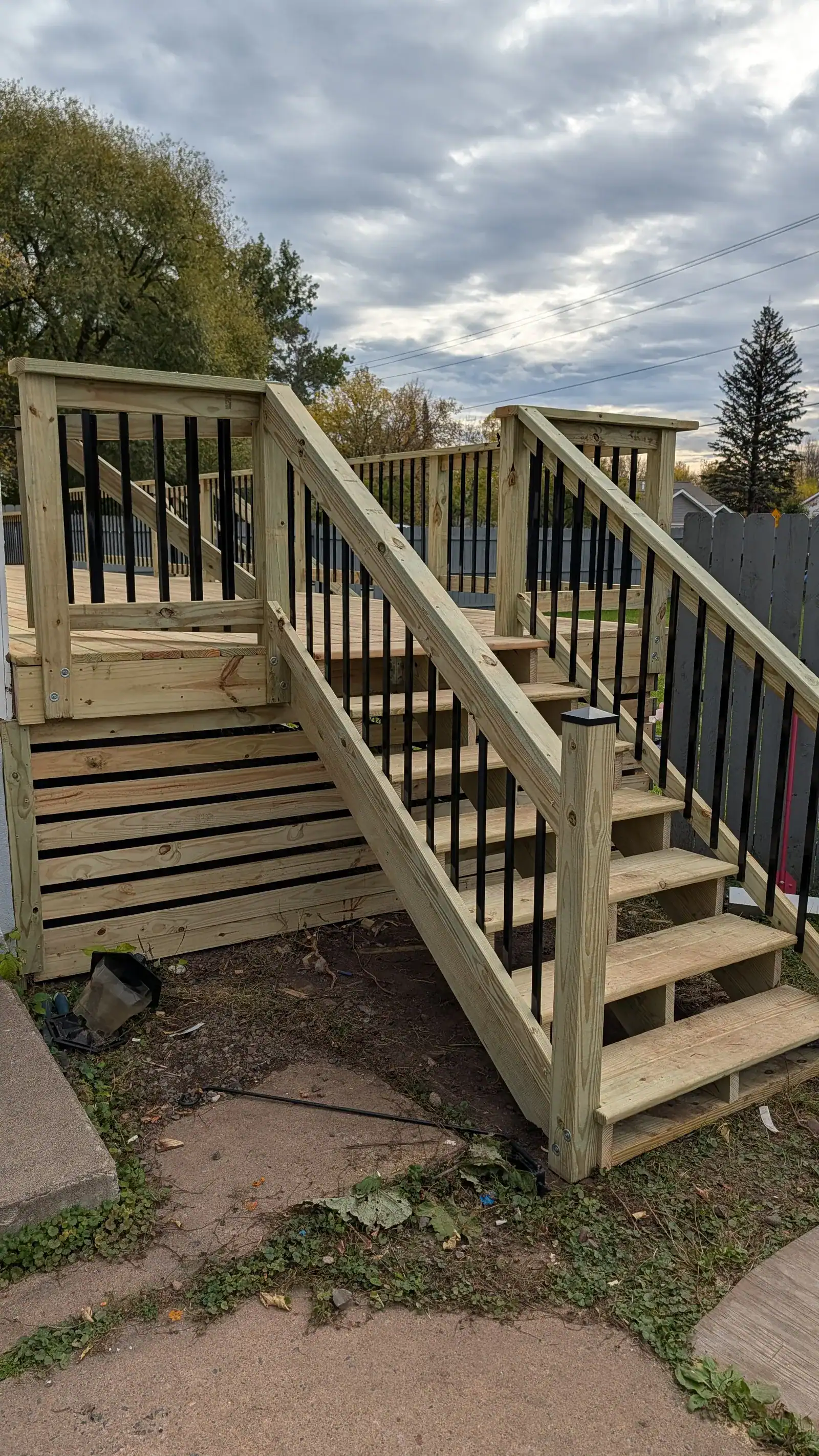 Completed custom deck build in Duluth, MN with pressure-treated lumber