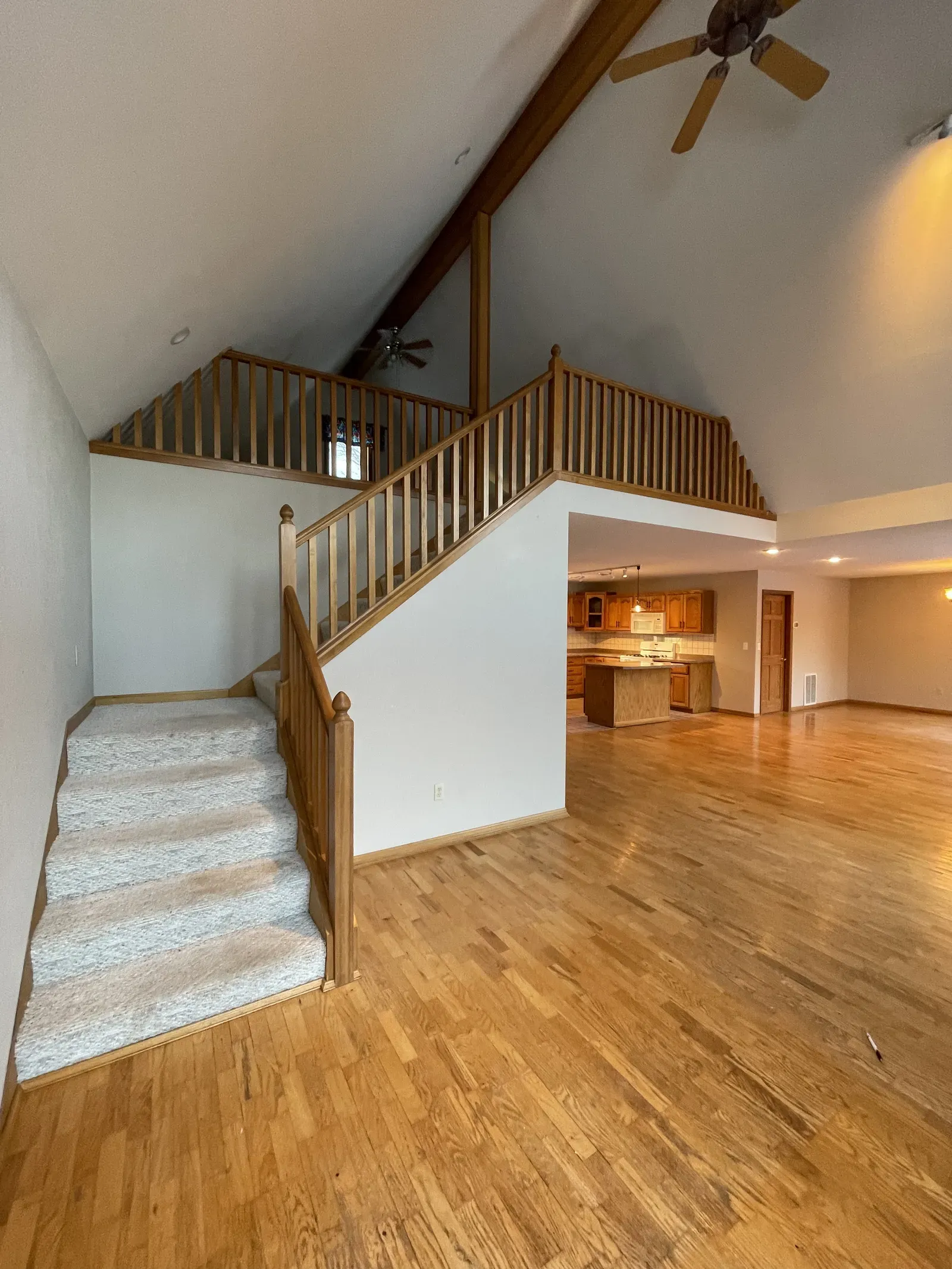Original loft with oak railing, carpet stairs, and dated ceiling